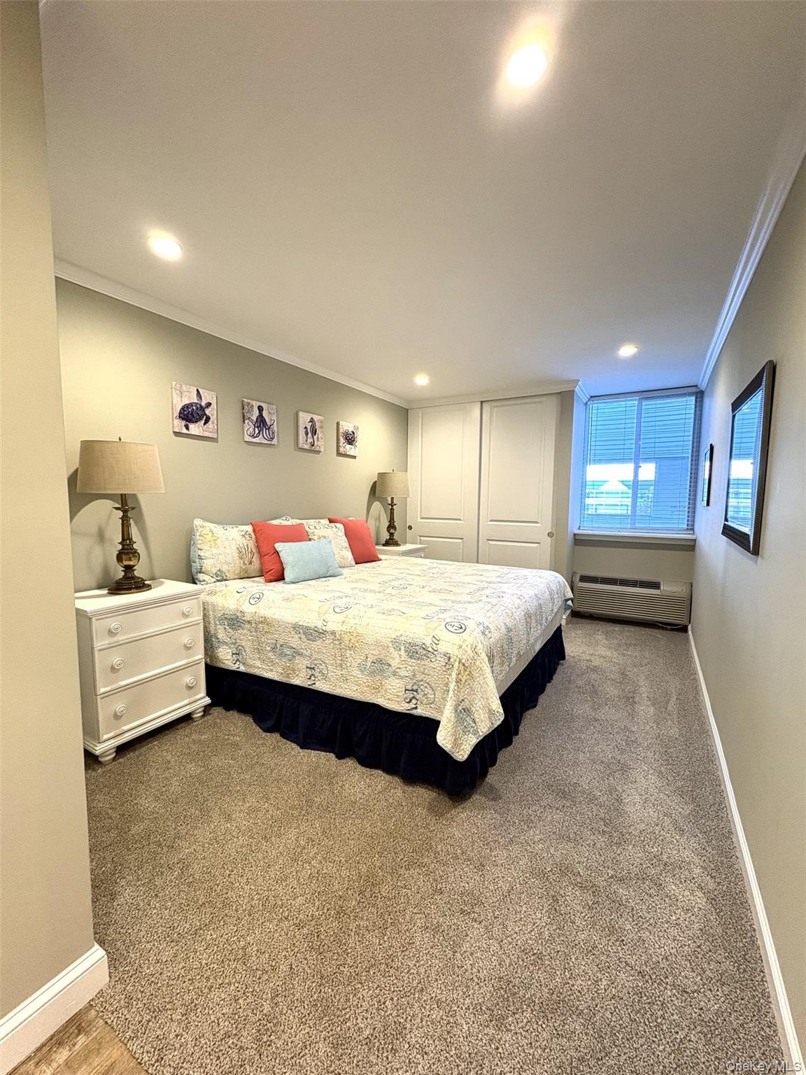 253 Dune Road, Unit 49 Westhampton Beach, NY 11978 - Photo 10 of 31 a bedroom with a bed and a view of kitchen