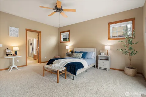 a spacious bedroom with a bed and a chandelier