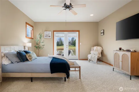 a bedroom with a bed and a flat screen tv