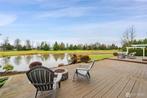 a view of a swimming pool with outdoor seating and hardwood