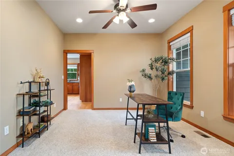 a view of a dining room with furniture and a book shelf