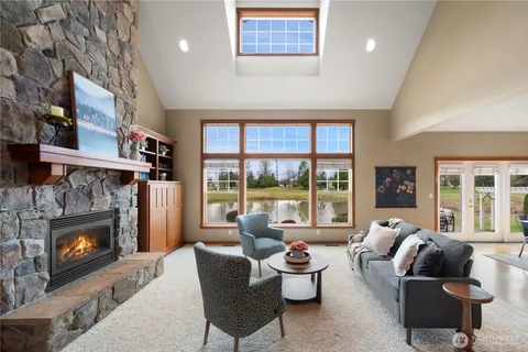 a living room with furniture fireplace and a large window