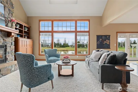 a living room with furniture and a floor to ceiling window