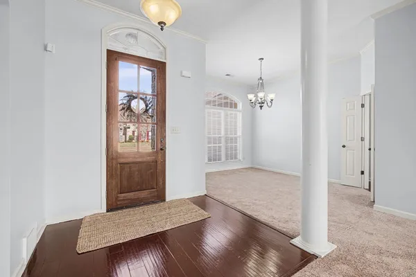 a view of an empty room with a fireplace and a window