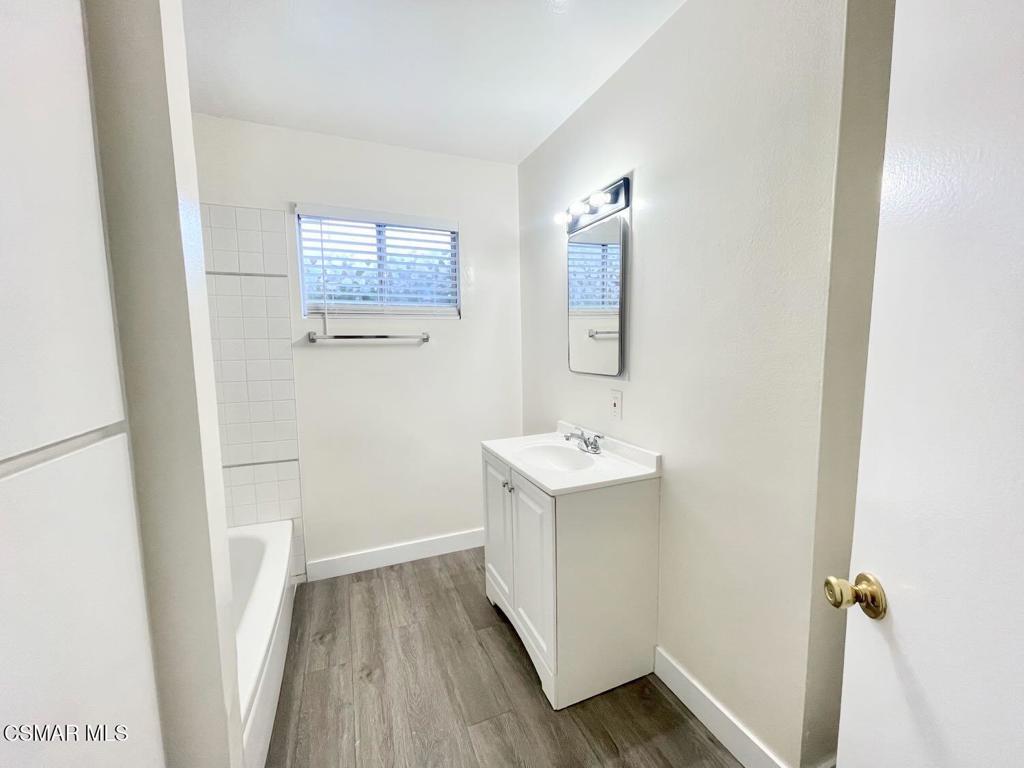 4120 Hi Drive Simi Valley, CA 93063 - Photo 18 of 29 a bathroom with a sink a mirror and wooden floor