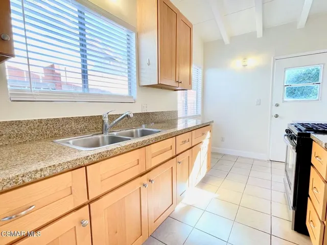 a kitchen with a sink cabinets and window