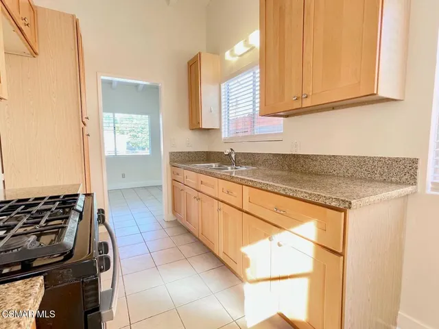 a kitchen with a sink stove and cabinets