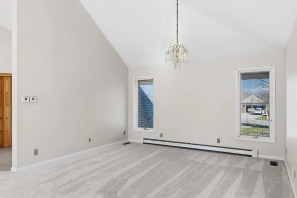 a view of a room with painting on the wall