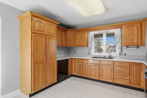 a kitchen with stainless steel appliances granite countertop a sink and cabinets with wooden floor