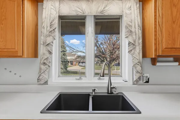 a kitchen with a sink and a window
