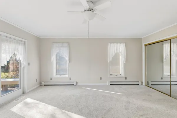 a view of a livingroom with a ceiling fan and window