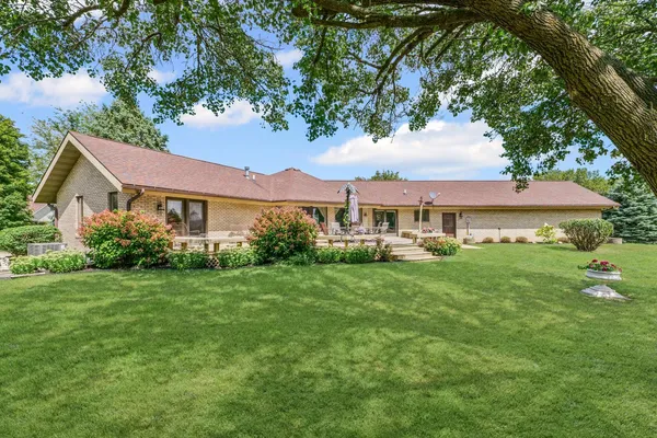 a view of a house with backyard sitting area and garden