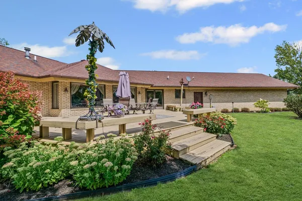 a view of house with yard outdoor seating and entertaining space