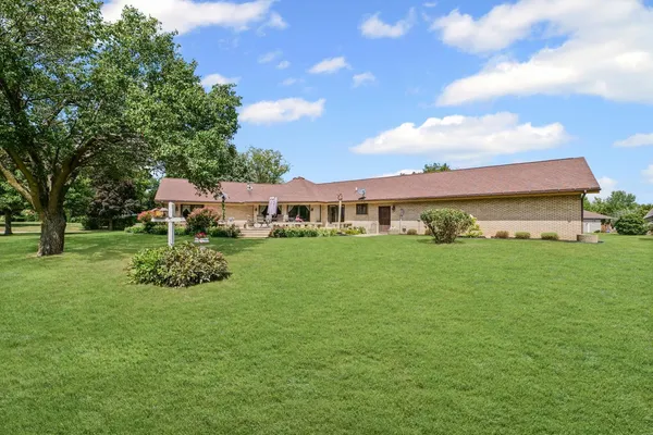 a view of house with garden space and trees