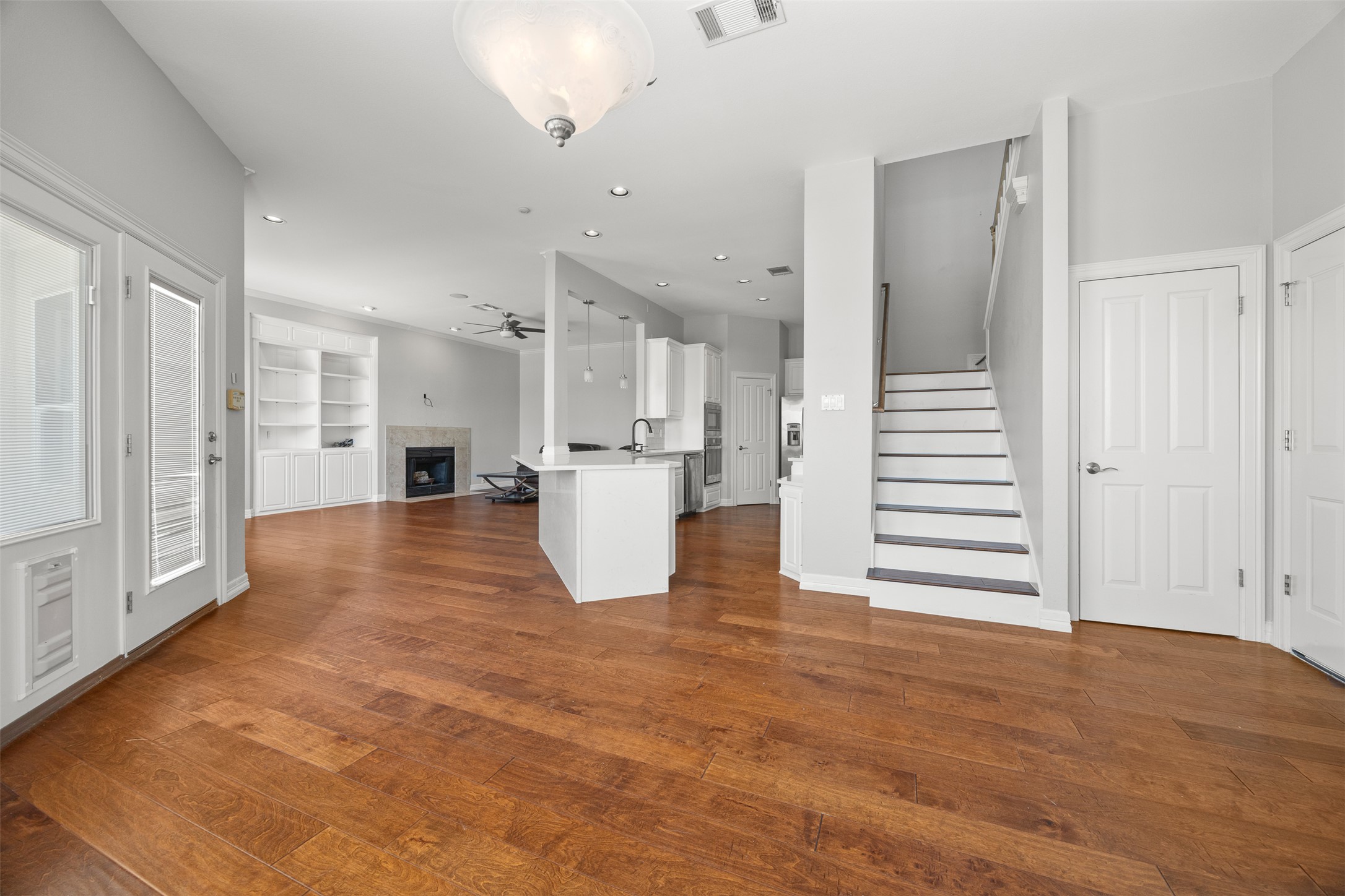 9300 Simmons Road Austin, TX 78759 - Photo 3 of 17 Rich hardwood flooring guides you through this flowing open concept living space.
