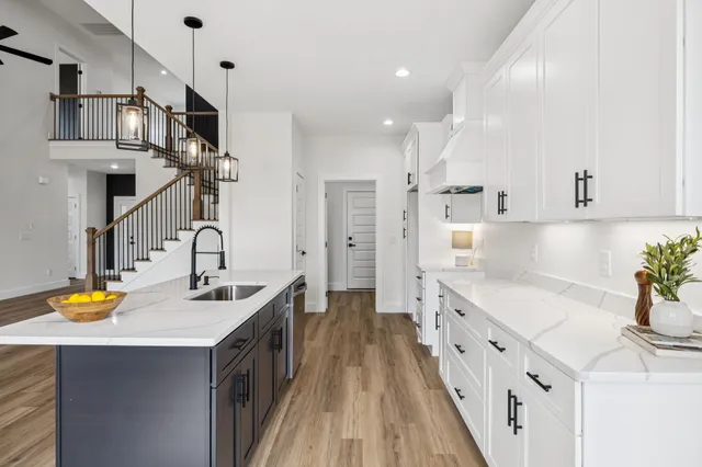 a view of walk in closet with wooden floor
