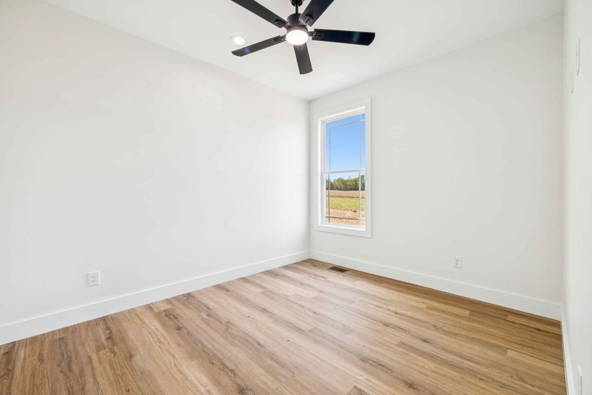 6437 Hopewell Road Springfield, TN 37172 - Photo 51 of 87 an empty room with wooden floor fan and windows