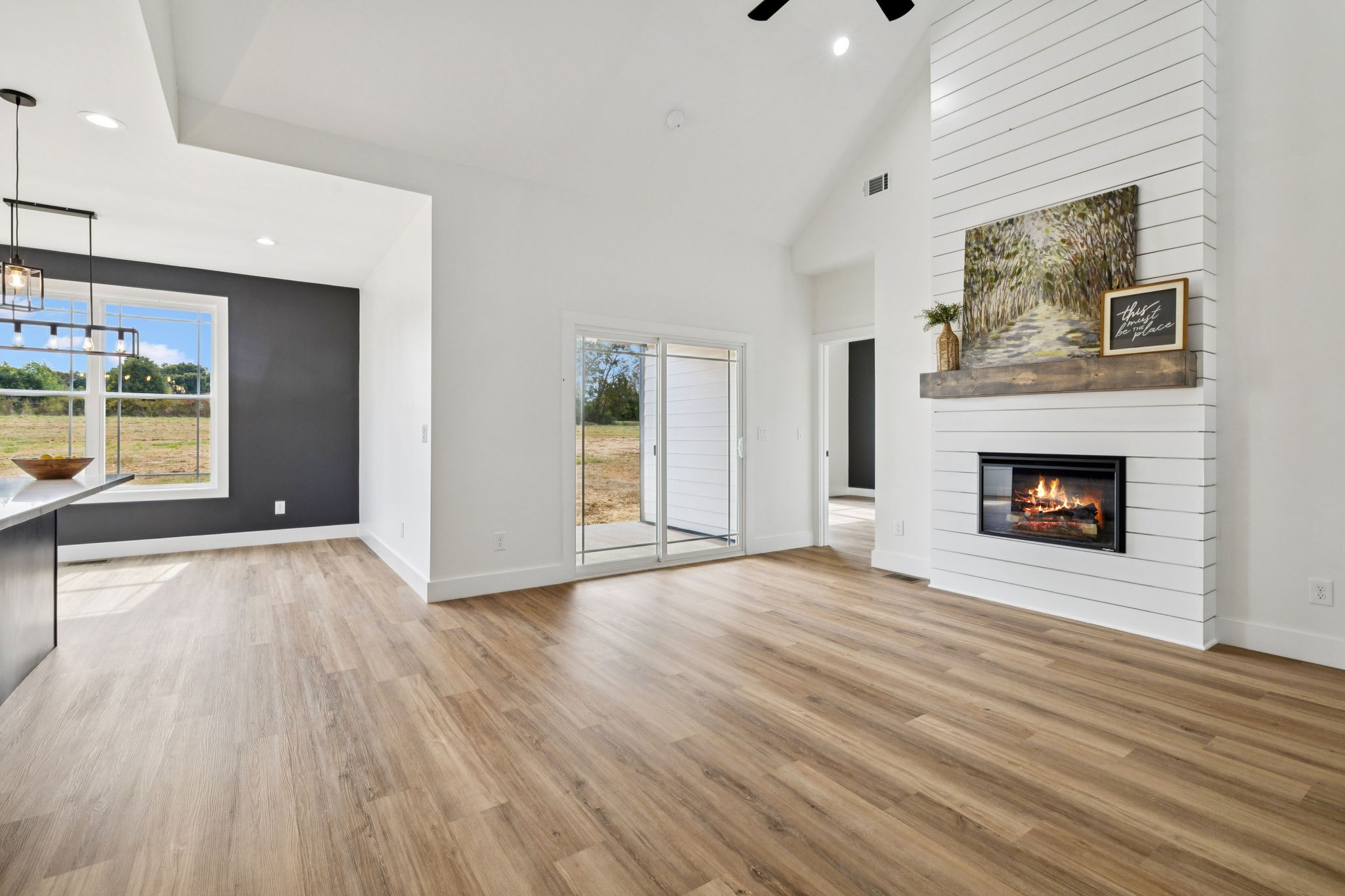 6437 Hopewell Road Springfield, TN 37172 - Photo 9 of 87 an empty room with wooden floor fireplace and windows