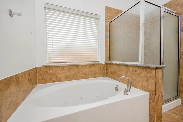 a white bath tub sitting next to a window