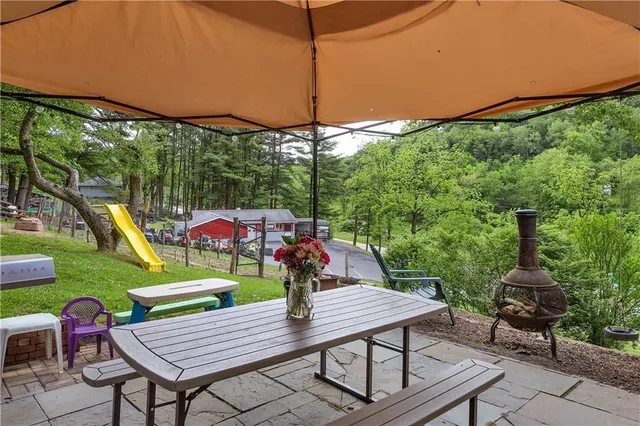 a view of a table and chairs in patio with a yard