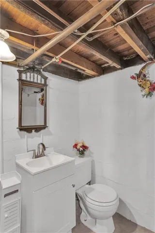 a bathroom with a sink vanity granite and toilet