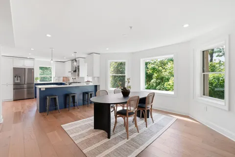 a view of a dining room with furniture window and wooden floor