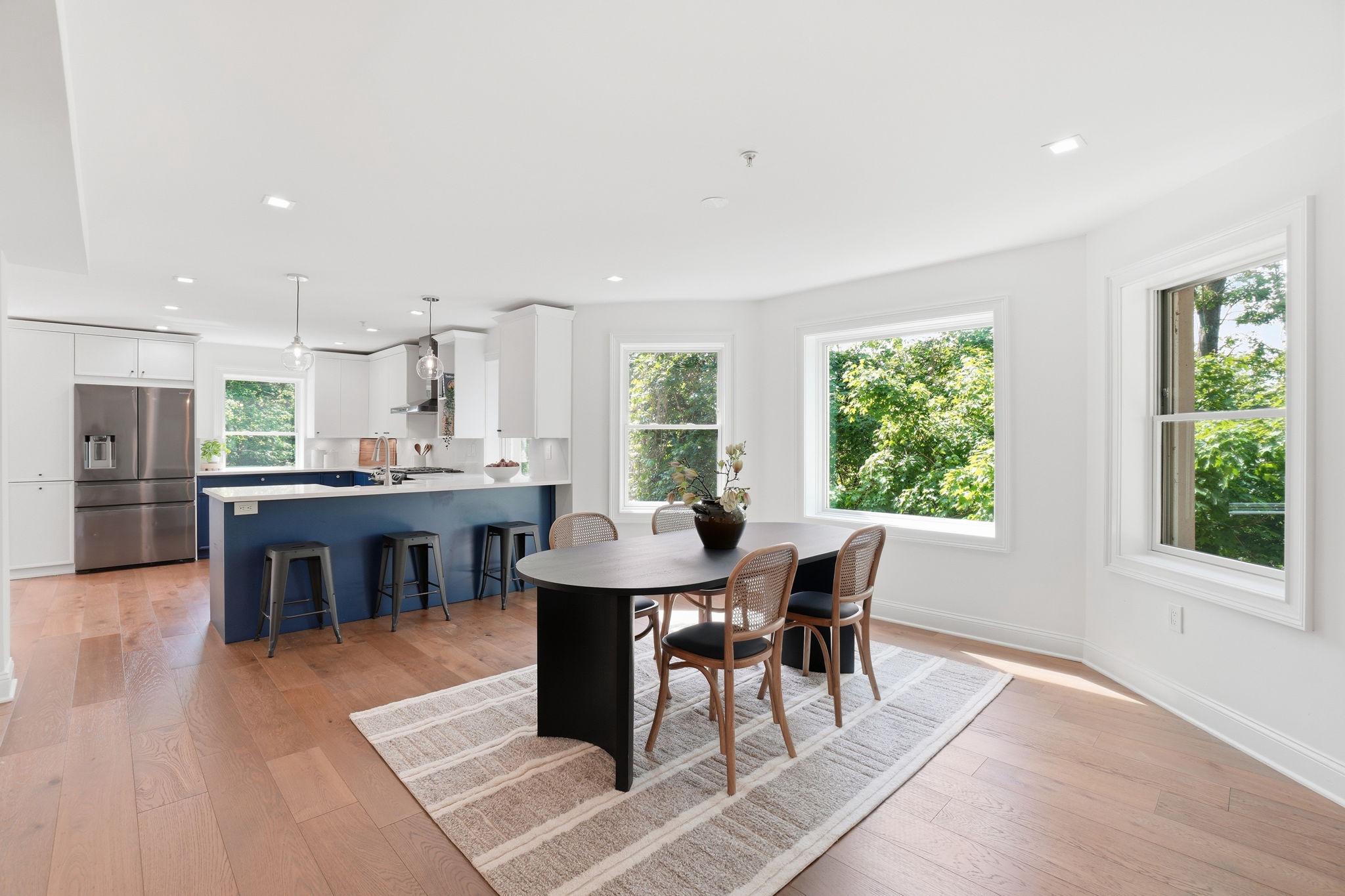 2800 Adams Mill Road Northwest, Unit 2 Washington, DC 20009 - Photo 11 of 32 a view of a dining room with furniture window and wooden floor