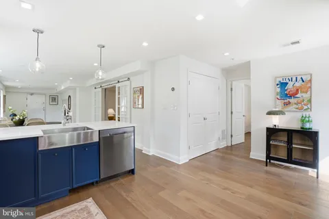 a kitchen with a sink cabinets and wooden floor
