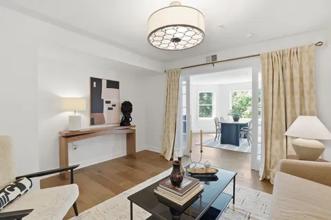 a living room with furniture and a chandelier