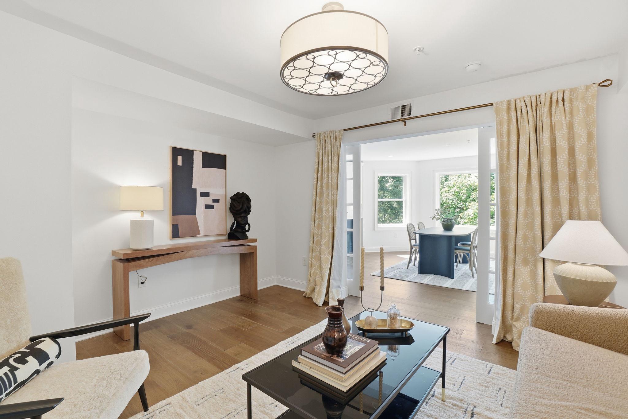 2800 Adams Mill Road Northwest, Unit 2 Washington, DC 20009 - Photo 17 of 32 a living room with furniture and a chandelier