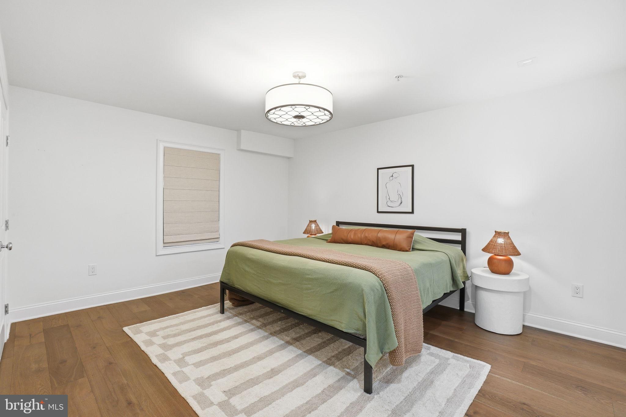 2800 Adams Mill Road Northwest, Unit 2 Washington, DC 20009 - Photo 19 of 32 a bedroom with a bed and a table