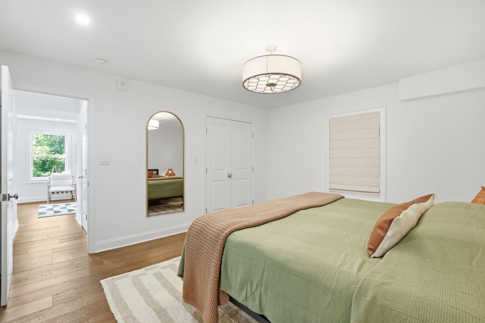 2800 Adams Mill Road Northwest, Unit 2 Washington, DC 20009 - Photo 22 of 32 a bedroom with a bed and a chandelier