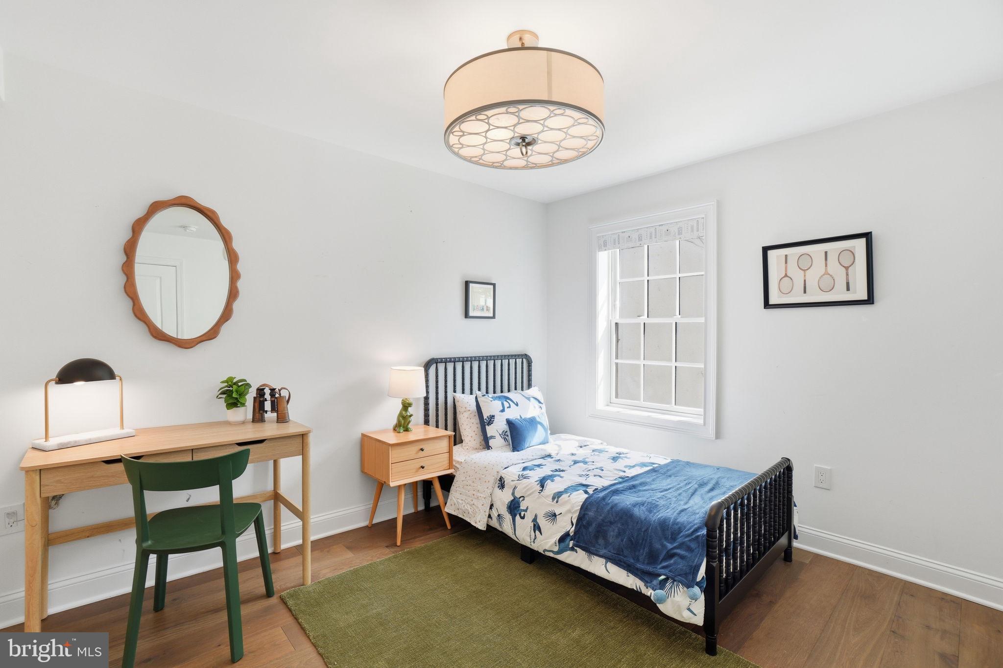 2800 Adams Mill Road Northwest, Unit 2 Washington, DC 20009 - Photo 24 of 32 a bedroom with a bed a chandelier and a window