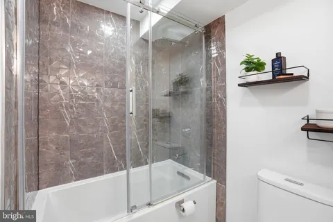 a bathroom with a bathtub and a shower