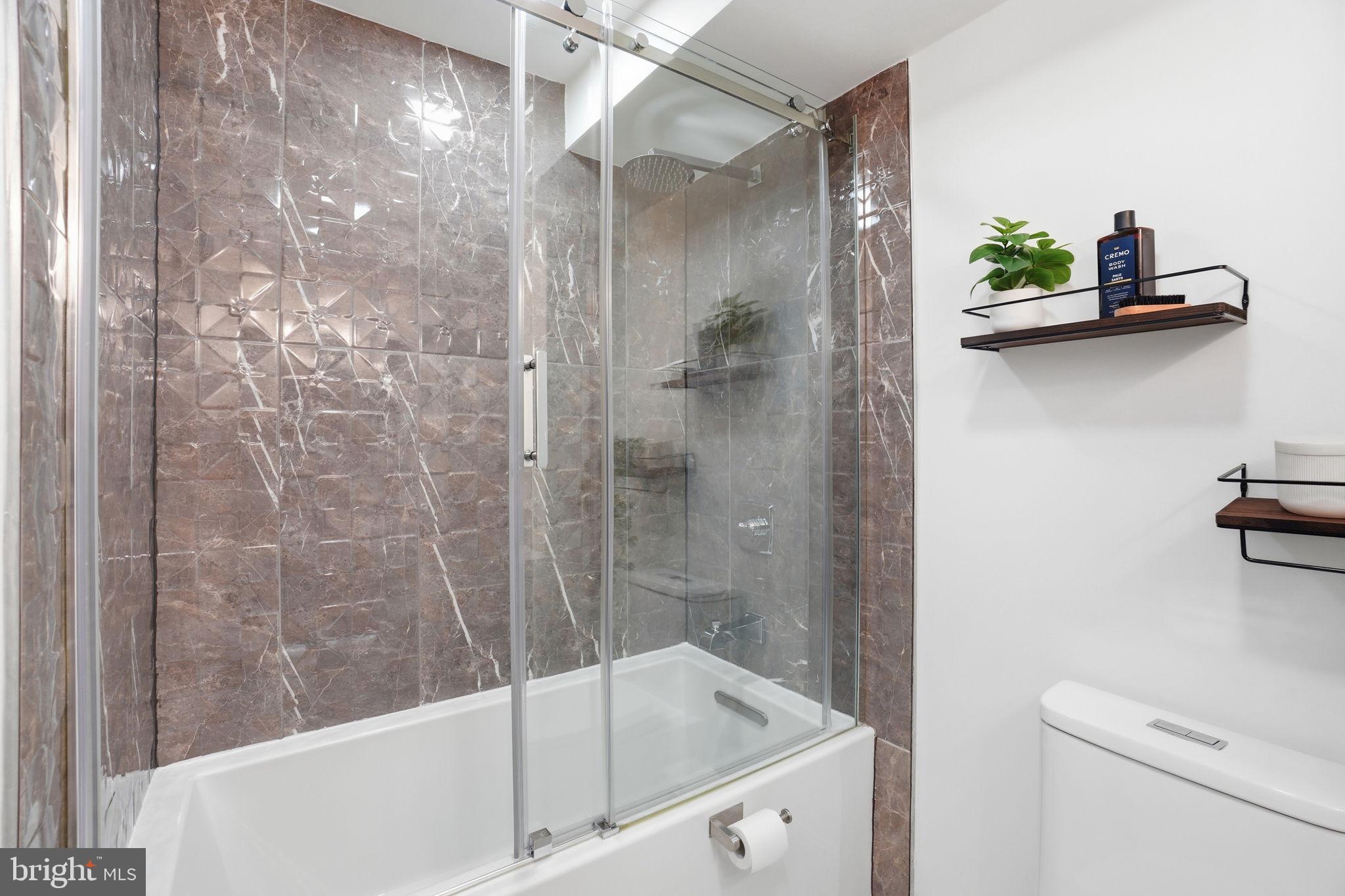 2800 Adams Mill Road Northwest, Unit 2 Washington, DC 20009 - Photo 27 of 32 a bathroom with a bathtub and a shower