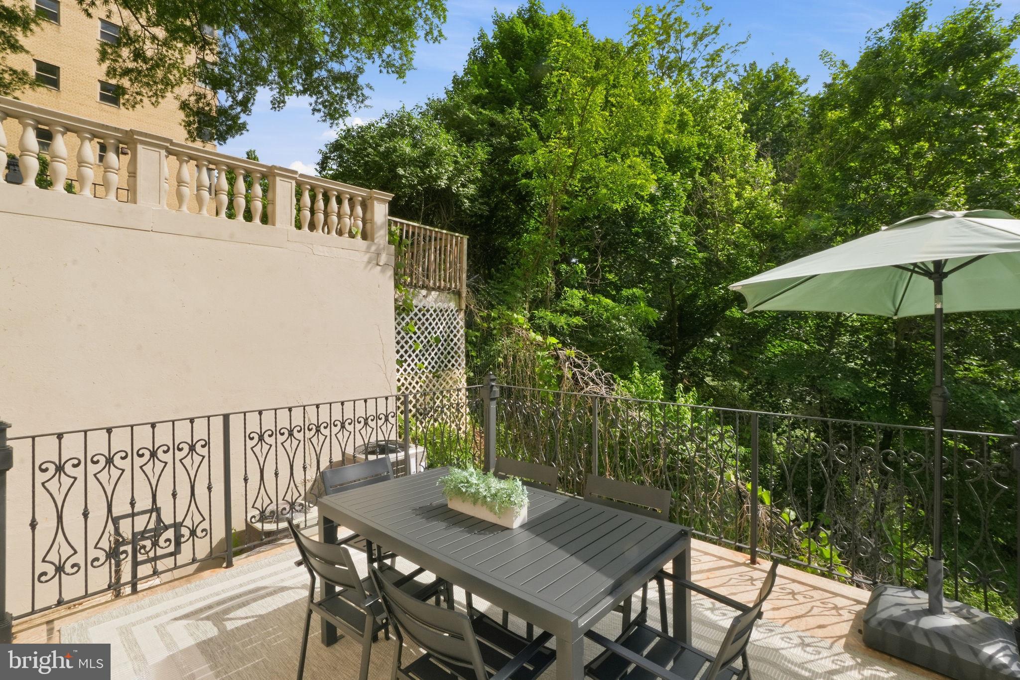 2800 Adams Mill Road Northwest, Unit 2 Washington, DC 20009 - Photo 6 of 32 a view of balcony with furniture and umbrella