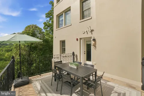 a backyard of a house with table and chairs
