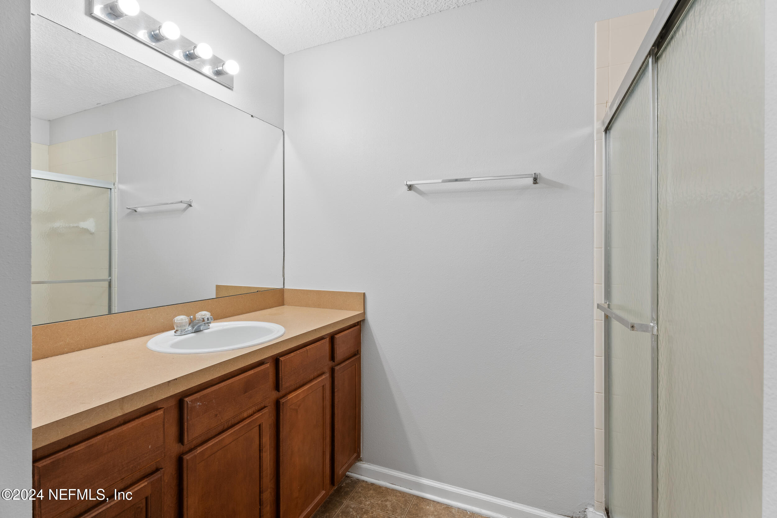 5260 Collins Road, Unit 1101 Jacksonville, FL 32244 - Photo 11 of 25 a bathroom with a granite countertop sink and a mirror