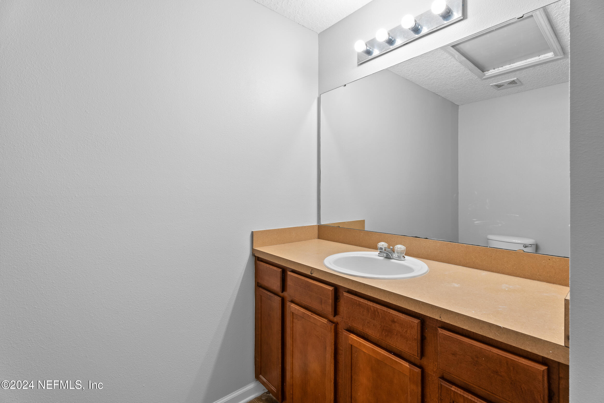 5260 Collins Road, Unit 1101 Jacksonville, FL 32244 - Photo 12 of 25 a bathroom with a sink and a mirror