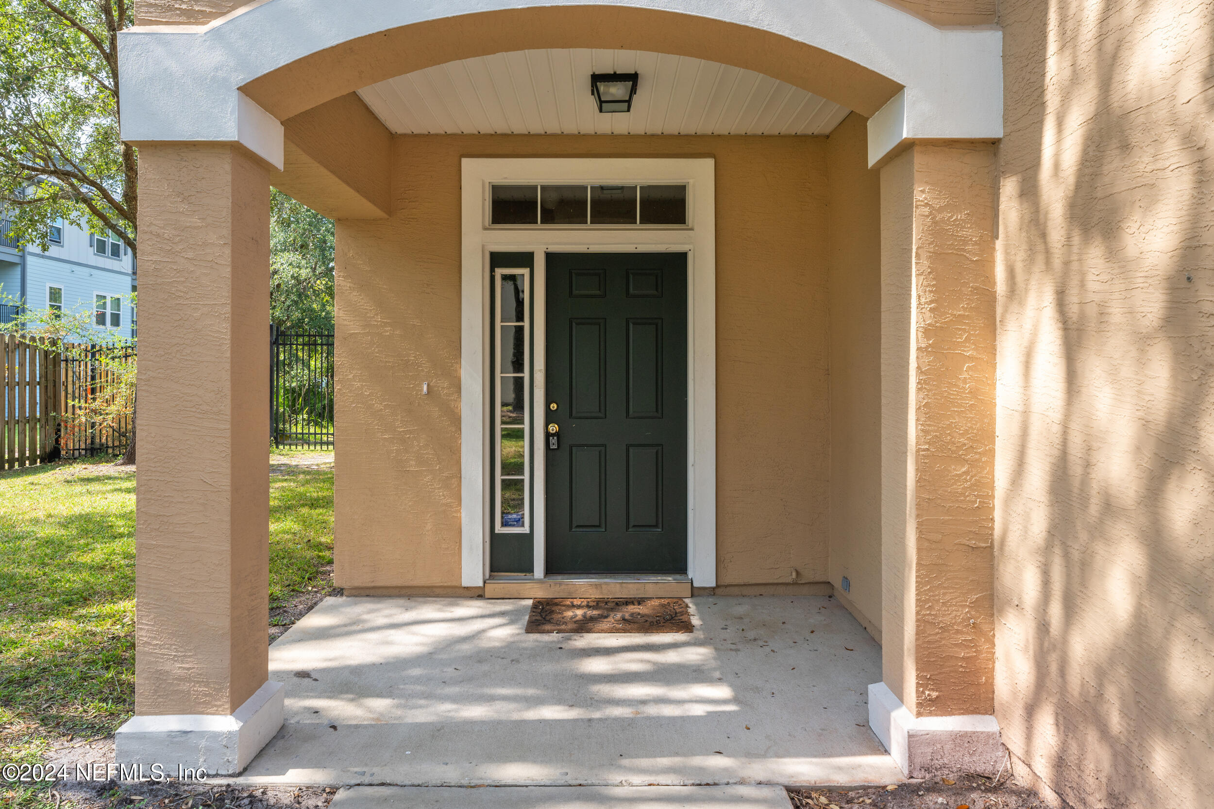 5260 Collins Road, Unit 1101 Jacksonville, FL 32244 - Photo 2 of 25 a front view of a house with a yard