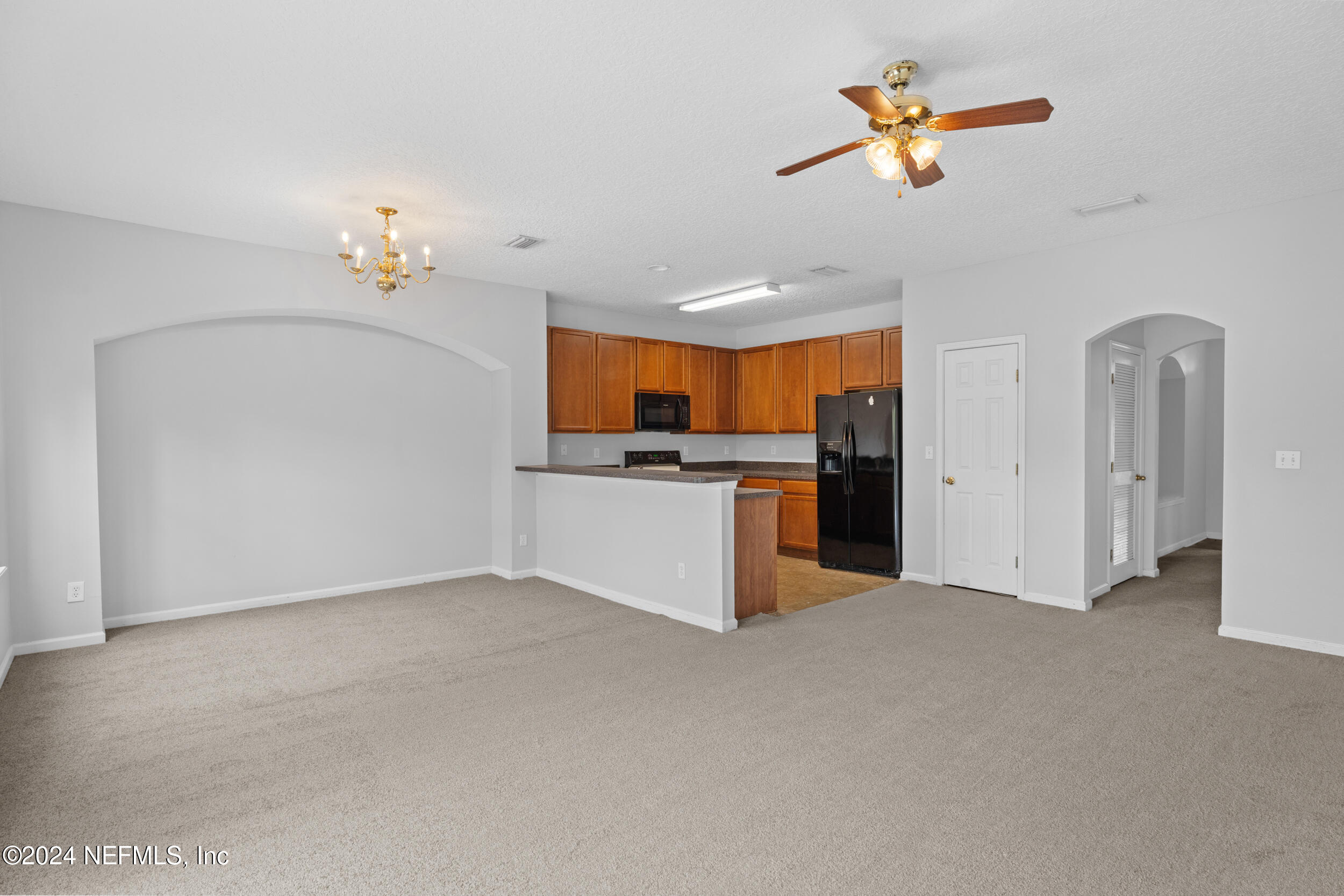 5260 Collins Road, Unit 1101 Jacksonville, FL 32244 - Photo 23 of 25 a view of a kitchen with a sink and cabinet chandelier