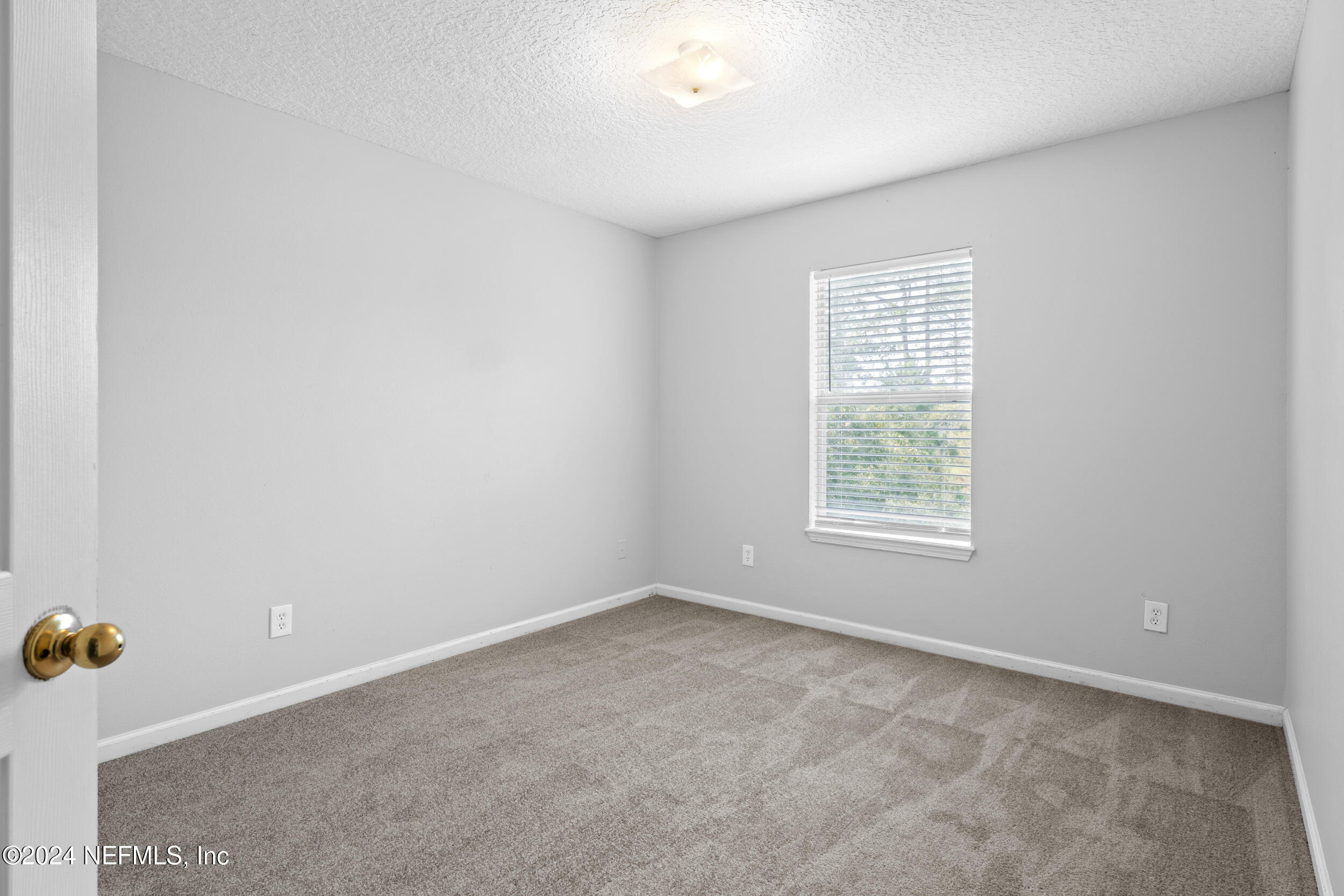 5260 Collins Road, Unit 1101 Jacksonville, FL 32244 - Photo 3 of 25 an empty room with a window