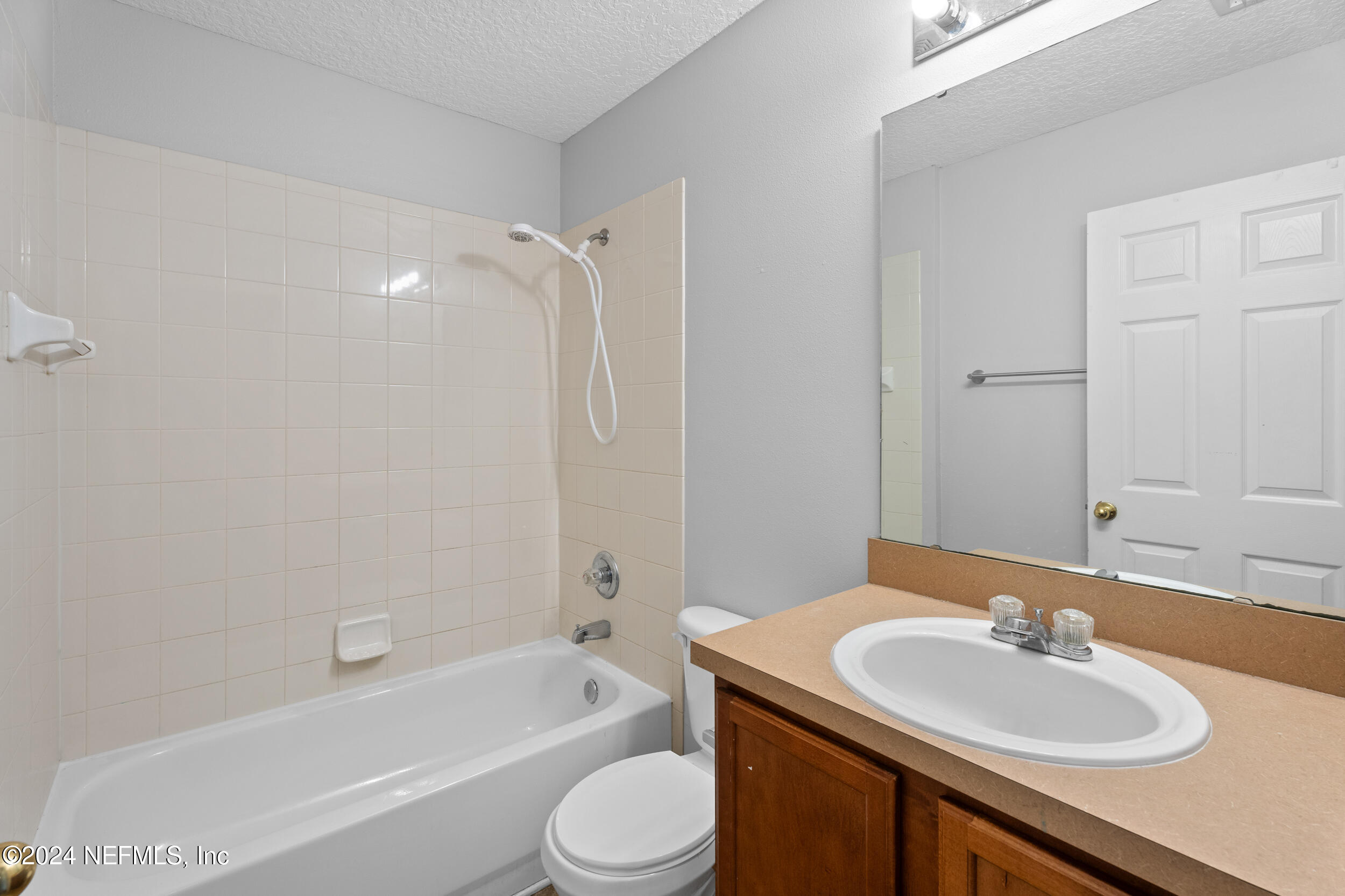 5260 Collins Road, Unit 1101 Jacksonville, FL 32244 - Photo 6 of 25 a bathroom with a sink toilet tub and shower