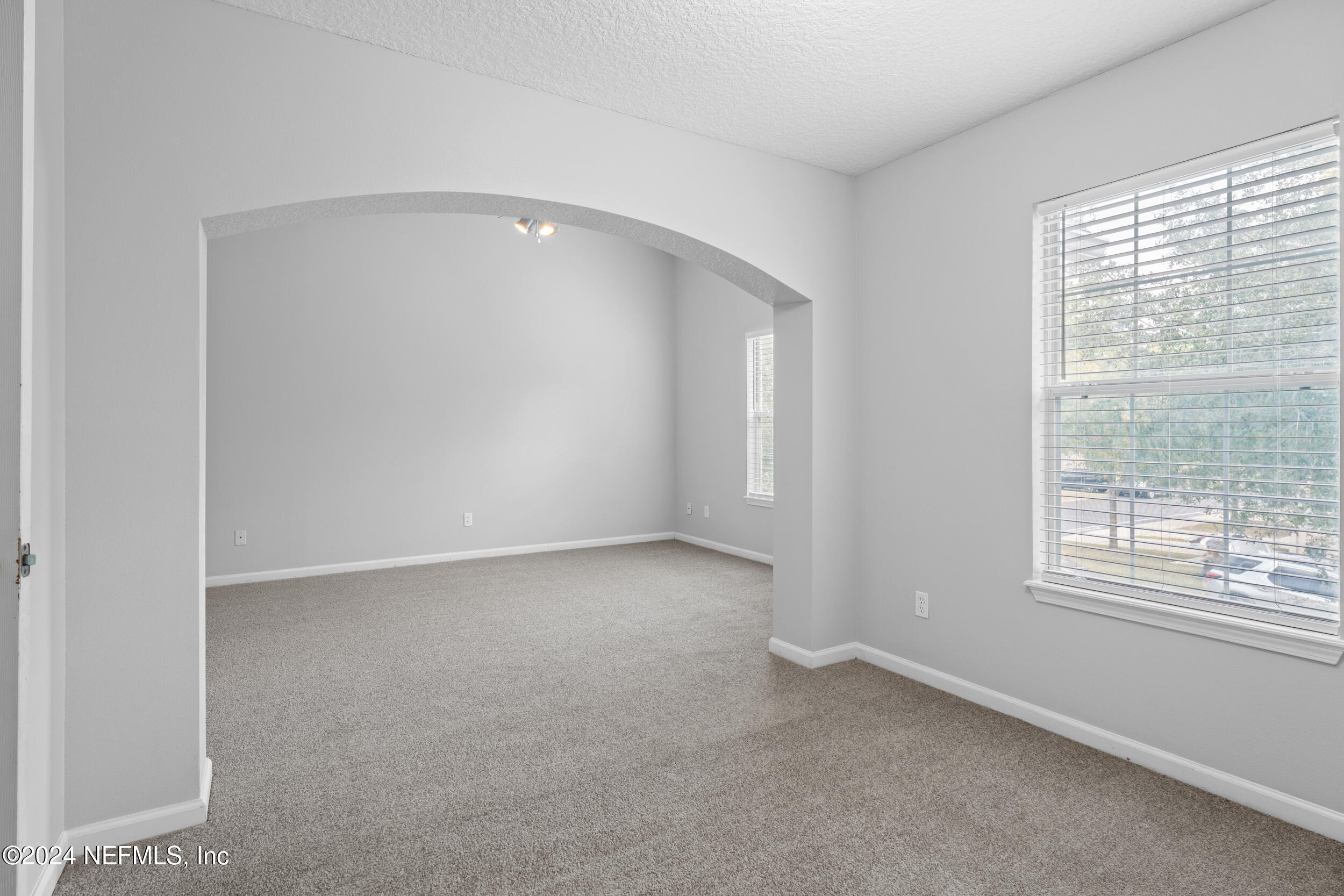 5260 Collins Road, Unit 1101 Jacksonville, FL 32244 - Photo 7 of 25 an empty room with a empty space and windows