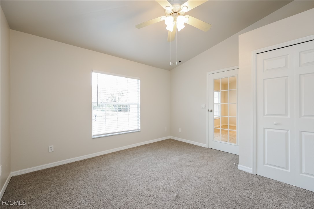 3004 15th Street West Lehigh Acres, FL 33971 - Photo 4 of 16 an empty room with windows and fan