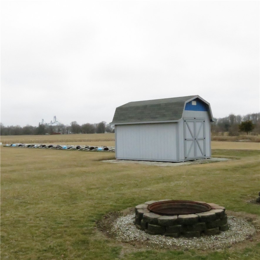 21242 Dingman-Slagle Road Pemberton, OH 45353 - Photo 33 of 33 This spacious yard features a practical shed and a charming fire pit, perfect for outdoor enjoyment.