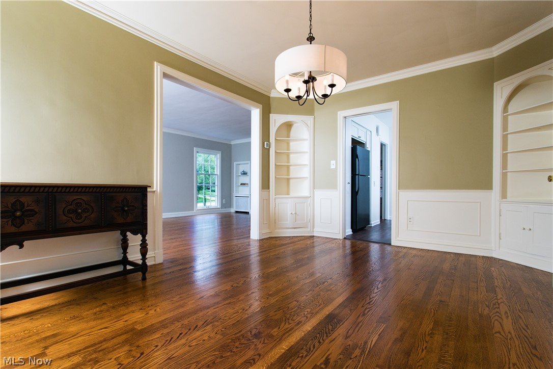 3622 Sutherland Road Shaker Heights, OH 44122 - Photo 4 of 21 The pretty Formal Dining Room features built-in cabinetry, Wainscoting and Chair Rail, Hardwood Floors, Newer Lighting and accesses the Family Room through French Doors to the right in this picture. Living Room is seen through the large Molding and Framing on the left.
