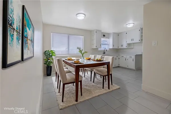 a dining room with furniture and window