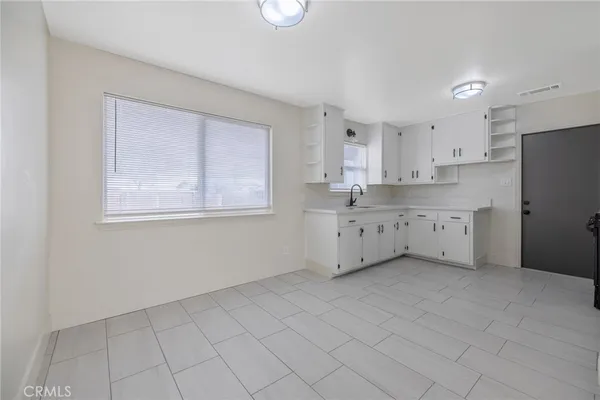 a kitchen with cabinets and stainless steel appliances