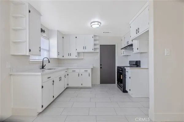 a kitchen with white cabinets